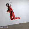 Bliss Dulce suspended in the air. Wearing a red cat suit.