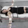 Arielle Lane is put to death by lethal injection. The colored liquid flows down the tubes and into her arms. She is tied to a table with her arms out.