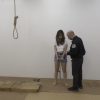 Woman in handcuffs and shackles about to be hung at the gallows. A TorvaFilms.com movie